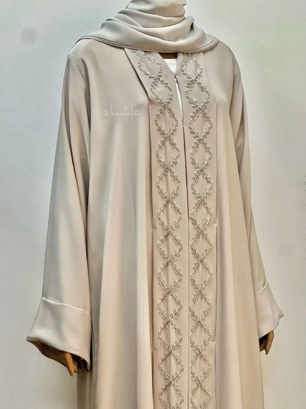 Close up view of White Nida premium abaya with delicate Zardosi handwork on the front panel and neckline, paired with a soft chiffon Sheila, offering a graceful and modest appearance.