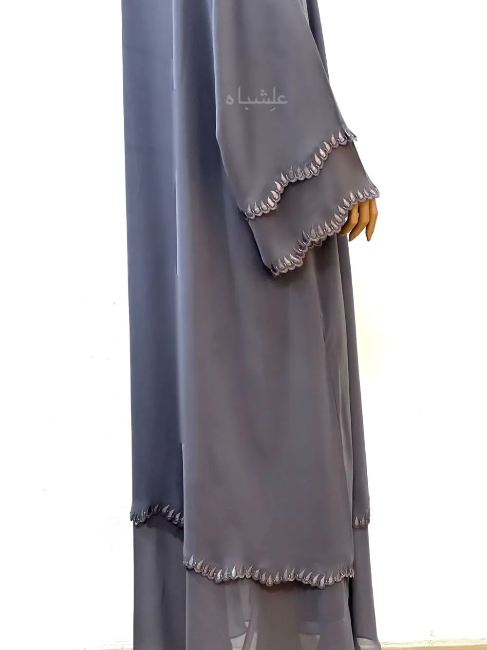 Close up view of A luxurious chiffon abaya with detailed embroidery and handwork on the sleeves