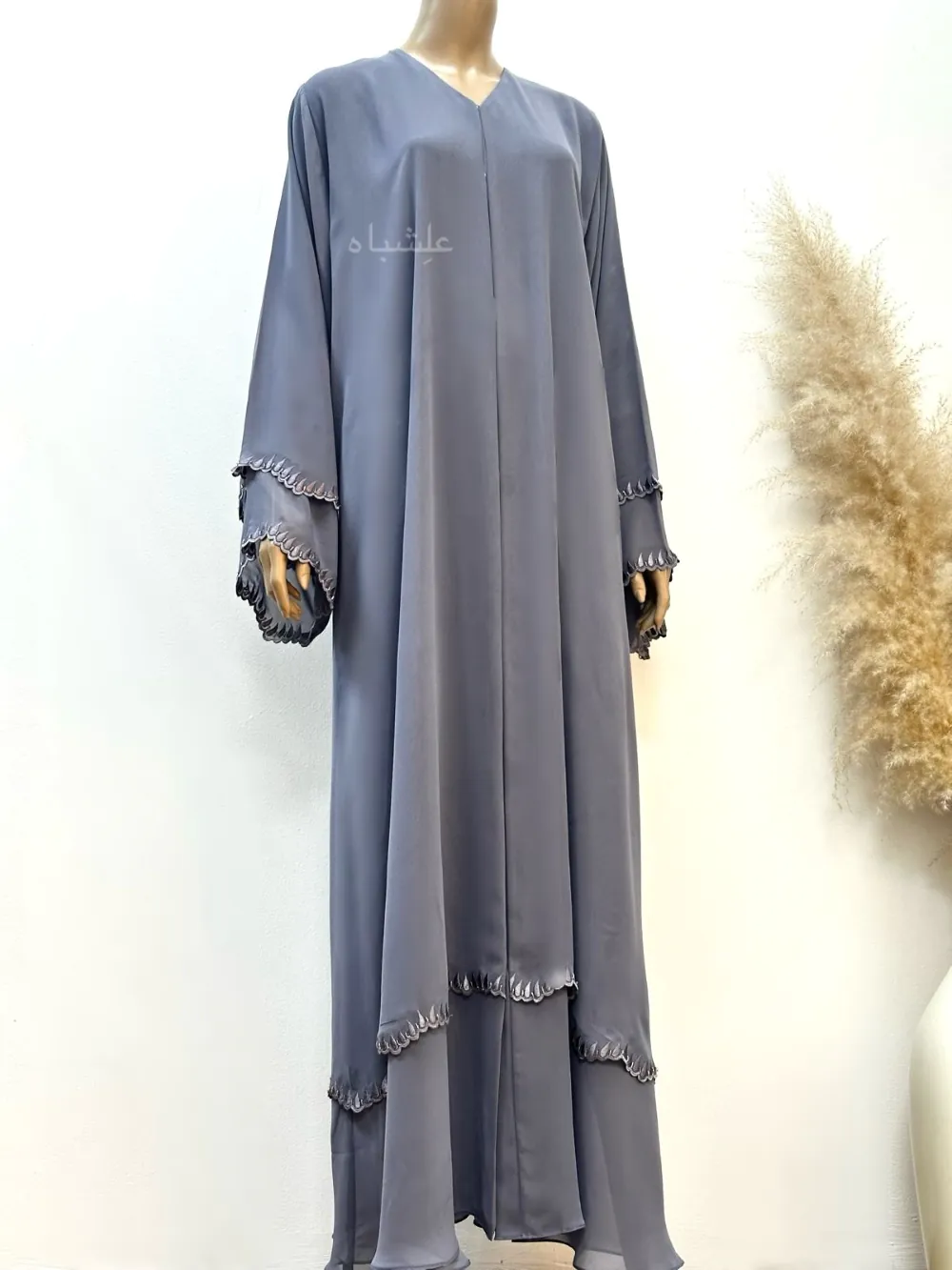 A luxurious chiffon abaya with detailed embroidery and handwork on the sleeves and bottom hem,