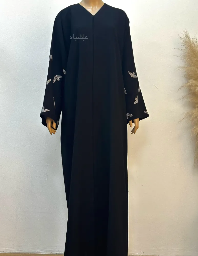 "Full front view of the Leaf Whisper Abaya on a mannequin, showcasing the black Ajwa Korea fabric and elegant embroidered sleeves without the sheila."