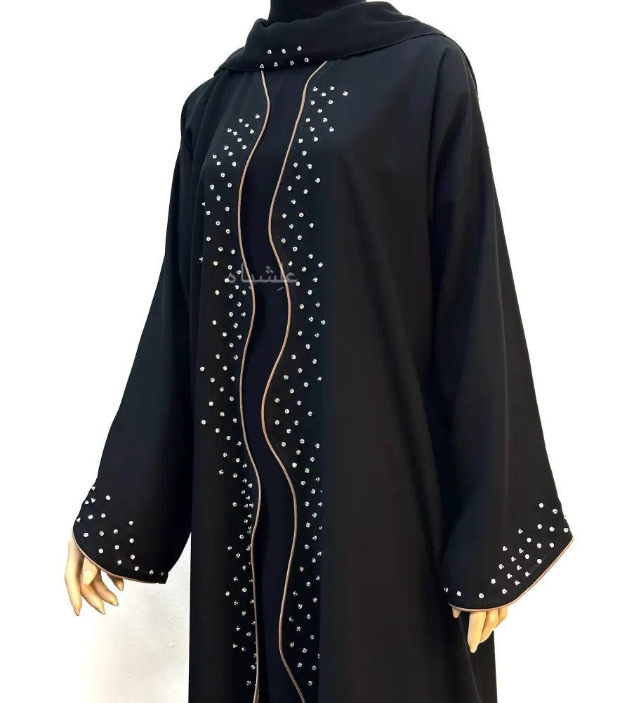 "Close-up front view of Wavy Grace Alishbah Abaya on a mannequin, highlighting hand-stitched details along the center and sleeves with matching chiffon Sheila."