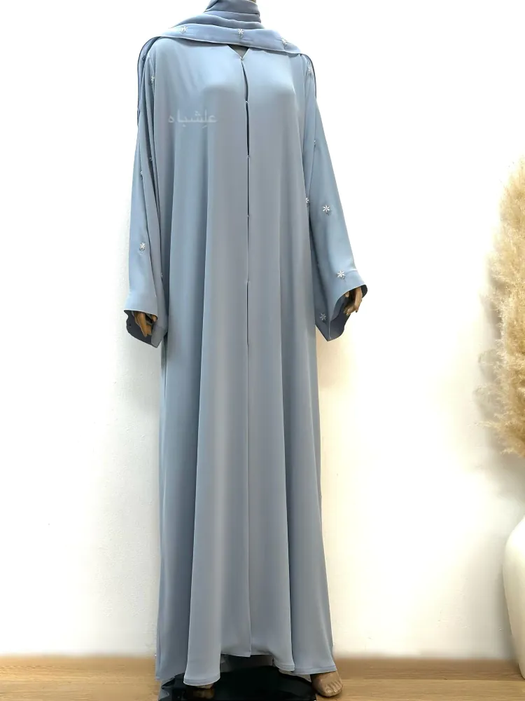 Front view of a full-length closed abaya made from Egyptian Crape, featuring floral details on the sleeves, paired with a matching soft chiffon Sheila.