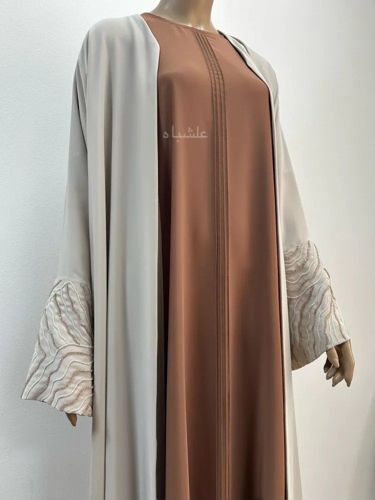 "Front close-up view of Radiant Harmony Abaya without sheila, showcasing pintuck details and intricate embellishments on premium Nida fabric."